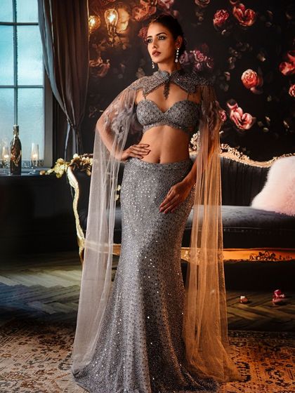 Elegance personified in shimmering silver. The projected backdrop of a luxurious, moody room adds a layer of glamour and sophistication, making the sequined gown sparkle.