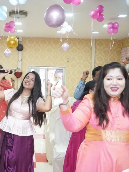 The energy in the room during a baby shower is always so positive. Here are some guests enjoying the dance and music, fully immersed in the celebration.
