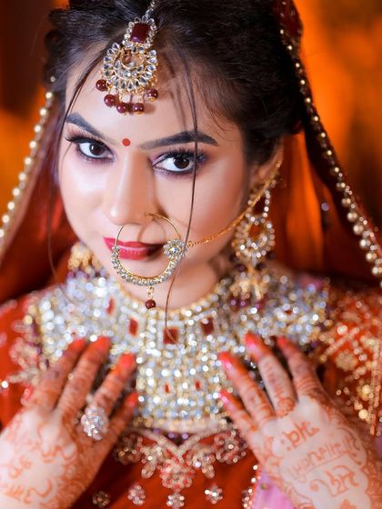 A striking portrait of a bride, looking directly into the lens. The focus is on her expressive eyes and stunning jewelry.