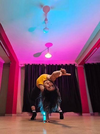 A dynamic dance pose captured mid-movement. The studio's lighting and clean background make it an excellent spot for a dance photoshoot to build your portfolio.