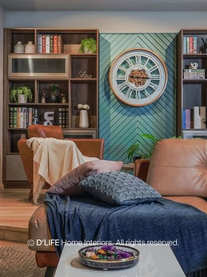 A comfortable and stylish living room with a large leather sectional, custom built-in bookshelves, and a large wall clock as a decorative feature.