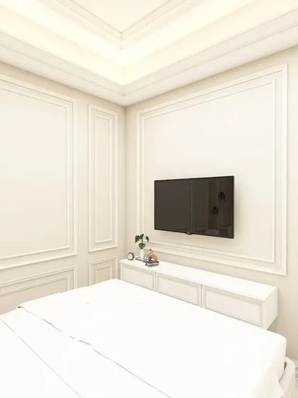 A 3D render of a master bedroom with a classic, all-white theme. The wall mouldings, floating nightstands, and a simple TV setup create a timeless and elegant look.