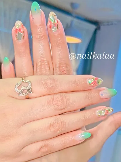 A vibrant set with a green ombre and encapsulated floral glitter. This design is fresh, colorful, and perfect for spring.