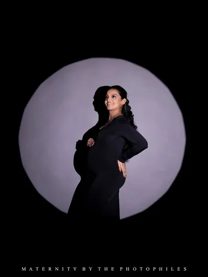 A dramatic spotlight portrait that creates a sense of being on stage. This technique highlights the mom-to-be's confidence and glow.