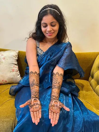 A beautiful bride-to-be, her hands adorned with intricate mehendi. She looks serene and ready for her big day.