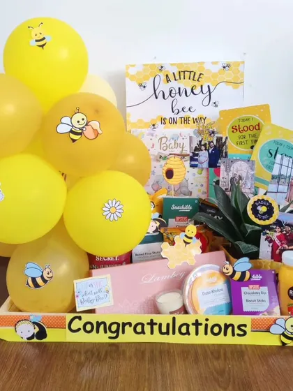 A 'Little Honey Bee' is on the way! This hamper is filled with bee-themed goodies, healthy snacks, and a small plant to congratulate the happy couple.