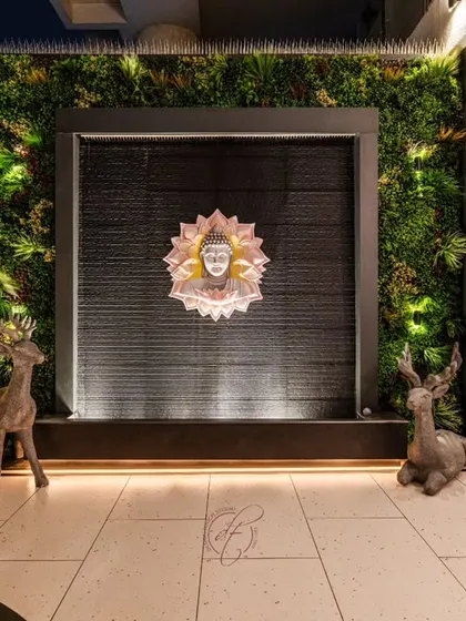 The focal point of the terrace is this serene Buddha water feature, framed by a lush green wall. The gentle sound of water and the soft lighting make it a perfect spot for meditation and relaxation.