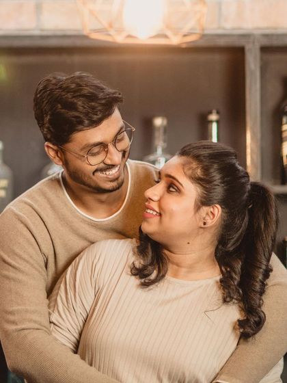 This cozy indoor shot shows a more casual look for the couple. I styled her hair in a simple high ponytail and kept the makeup minimal and fresh, perfect for this relaxed and happy moment.