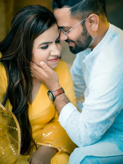 A close-up shot that highlights the couple's connection. The groom gently holds the bride's face, creating a romantic and tender pre-wedding photograph.
