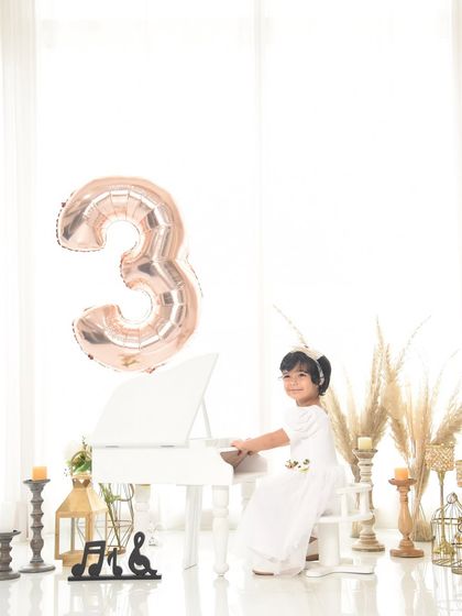 A wider view of the minimalist boho setup for a third birthday, showing how simple elements can create a beautiful and sophisticated portrait.