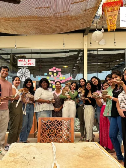 A day of pottery, puppies, and pure joy! This group shot from our workshop with an animal rescue centre shows everyone holding their clay creations and some furry friends.