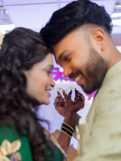 A sweet moment as the couple shows off their engagement rings. This shot is all about celebrating the symbol of their commitment to each other.