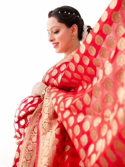A dynamic shot capturing the beautiful movement of the saree's fabric. This artistic portrait highlights the texture and flow of the traditional garment, creating a sense of timeless grace.