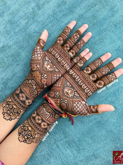 The full mehendi for the 'tapasvi', showing how the floral armbands are paired with intricate patterns on the hands.