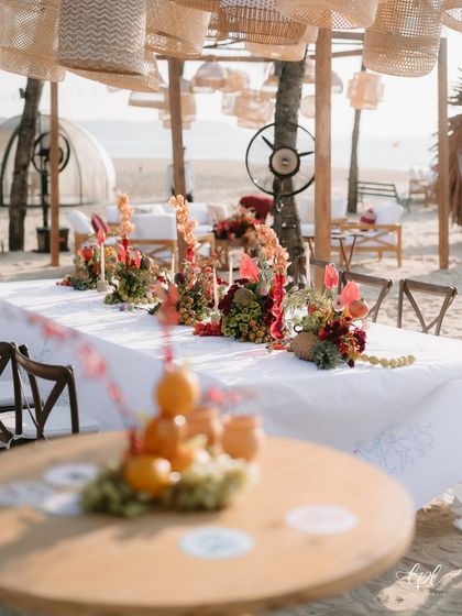 A wide shot of the beachside dining setup, with the ocean in the background.