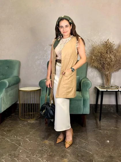 Even my western wear gets a festive touch during the holidays. I've layered a neutral vest over a lace top and paired it with a silk scarf as a headband to create a look that's both festive and bohemian.