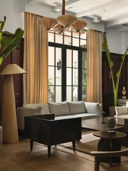 A view of the lounge seating, showing the interplay of different furniture styles and the way natural light activates the space.