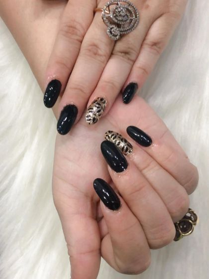 A close-up of the detailed leopard print nail art.