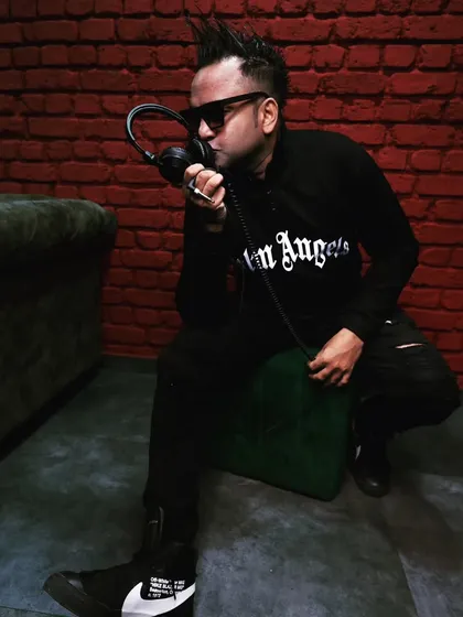 A full-body shot from a recent shoot, showing off my edgy style against a brick wall backdrop. My image is an extension of the energetic music I play.