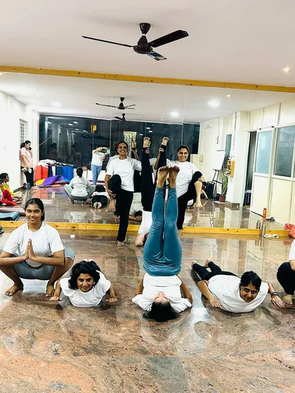 The front view of this playful group pose. It shows the smiles and concentration of students enjoying their practice and each other's company.