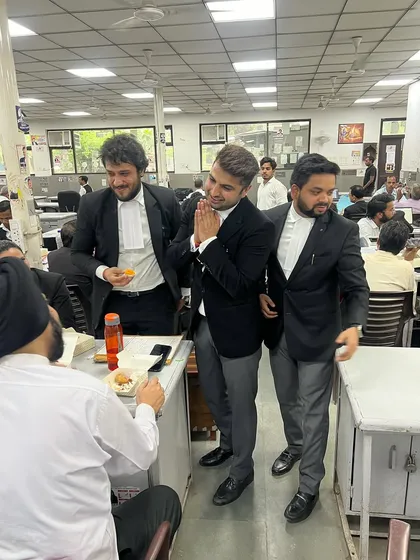 Seeking blessings from a senior member in the bar library. Respect for elders is paramount.