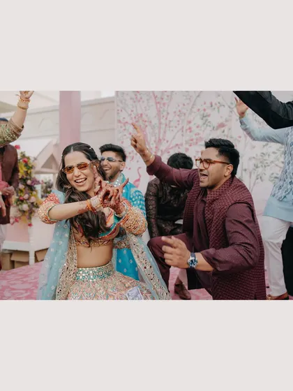 Pure energy and fun on the dance floor. This candid shot captures the couple letting loose and enjoying their celebration with friends, showcasing the joyful and high-energy moments of the day.