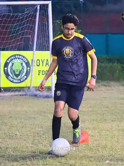 Focus and precision. A player navigates a cone drill, keeping the ball close to his feet. These exercises are essential for developing the technical skills needed for advanced play.