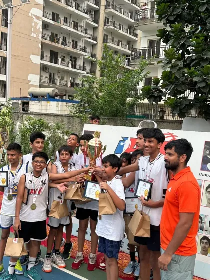 The joy of victory. Our U-14 boys' team with their coach, celebrating a hard-fought tournament win. These moments make all the sweat worth it.