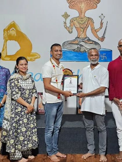 A student is awarded his certificate for the October TTC, marking a new chapter in his yoga journey.