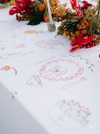 A detail of the interactive table runner, with illustrations of the couple's favorite things.