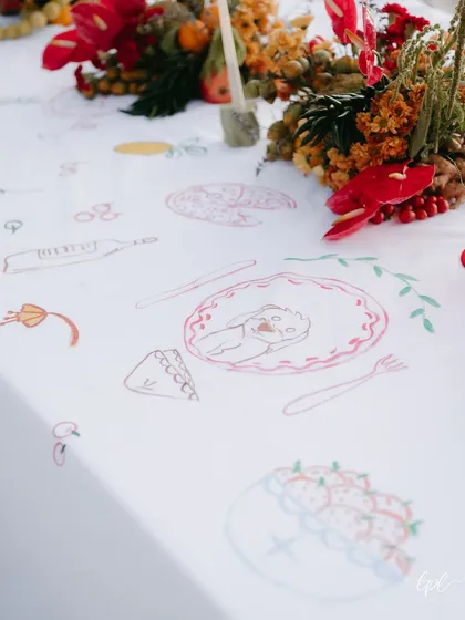 A detail of the interactive table runner, with illustrations of the couple's favorite things.