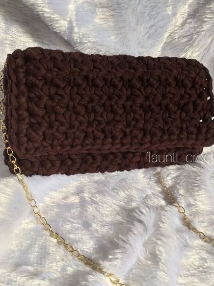 A different angle of the brown T-shirt yarn sling bag. The color is versatile and the design is modern, perfect for a chic accessory.
