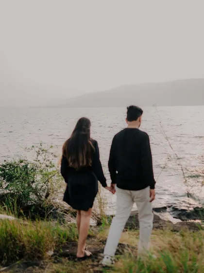 The couple walking away hand-in-hand, looking towards the horizon. This image symbolizes their journey forward together, creating a hopeful and cinematic feel.