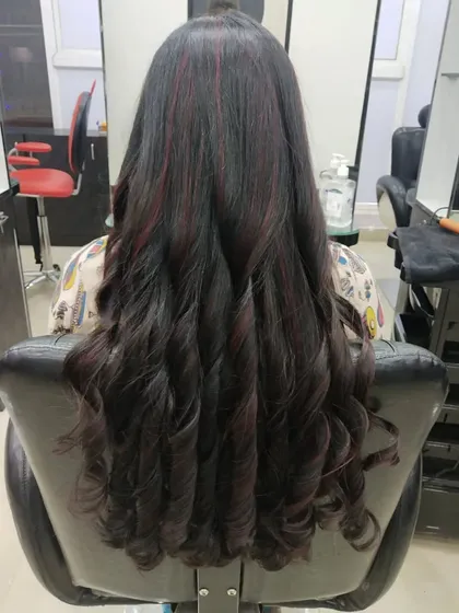 I love creating these big, glamorous curls after a color service. They perfectly showcase the subtle red highlights woven into the dark hair.