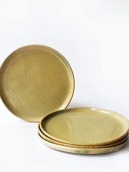 A set of our classic side plates in a warm, earthy lemon-green glaze with subtle speckles. These versatile plates are perfect for everyday meals, salads, or desserts.