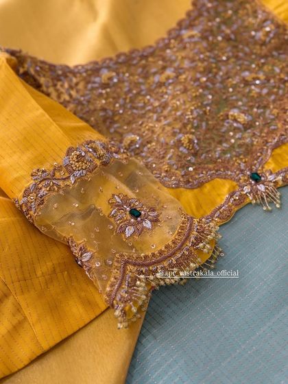 A yellow blouse with sheer sleeves, featuring floral motifs and pearl tassels.