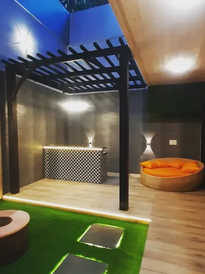 The bar and lounge area at night. The dark walls and warm lighting create an intimate and moody atmosphere.