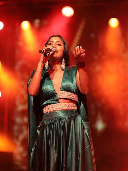 The lighting captures the sheen of the satin fabric beautifully. This is a great example of a custom-designed stage outfit.