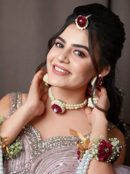 A bright and happy Sangeet look. The makeup is kept fresh and radiant to match the playful vibe of the floral jewelry and the event.