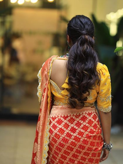 A back view of the textured ponytail. The waves add volume and interest to this classic hairstyle.