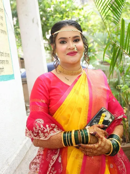 A confident and happy bride. Her makeup is fresh and glowing, perfect for a daytime wedding ceremony, and her smile is the best accessory.