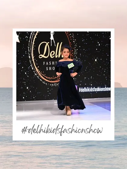 An elegant, deep blue velvet dress gives this participant a sophisticated and classic look. The professional stage ensures that even darker outfits pop under the lights.