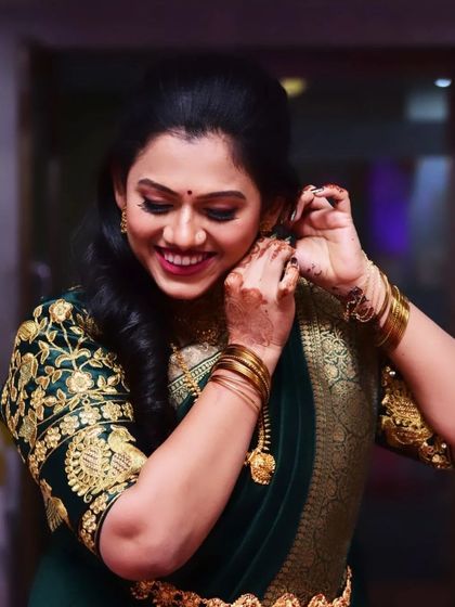 A candid shot of a bride getting ready for her engagement. The soft makeup and elegant hairstyle create a look of timeless beauty.