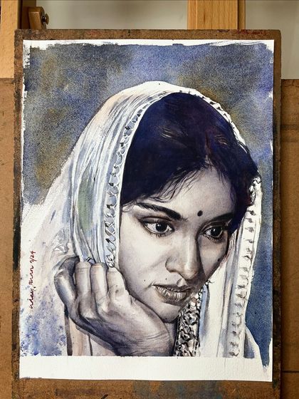 The Vyjayanthimala portrait on my easel, next to my palette. This gives a behind-the-scenes look at the colors and tools used.