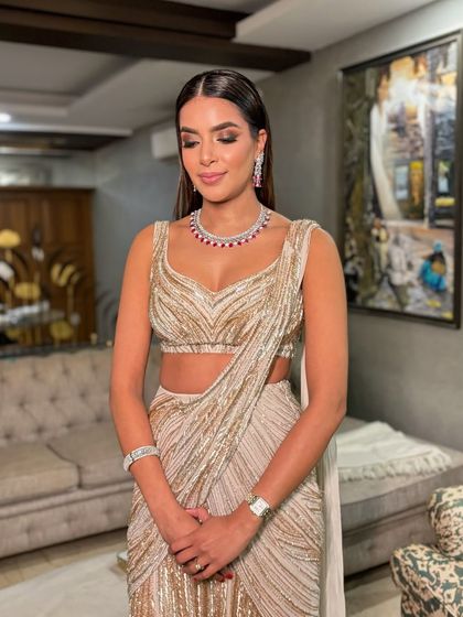 A portrait of this glamorous look. The makeup is sophisticated and lets the outfit's intricate details shine.