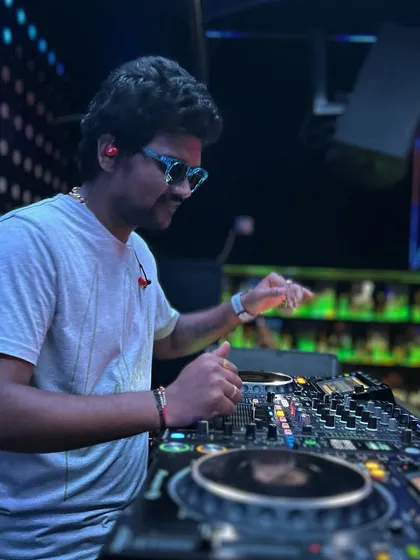 A cool shot of me at the console, surrounded by the club's ambient lighting, deep in the mix.