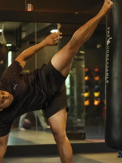 We teach more than just punches. This is a Muay Thai high kick being practiced on the heavy bag. Learning to use kicks, knees, and elbows turns your whole body into a tool for building power.