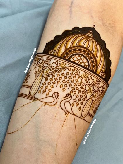 The initial outline of a beautiful arm band. This sketch shows the placement for two swans in a decorative arch, ready to be filled with intricate details.