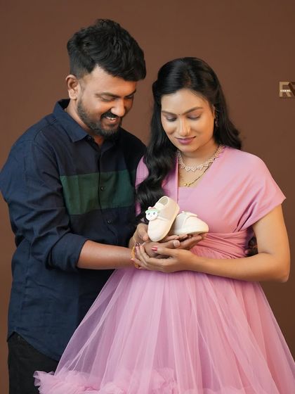 A close-up shot focusing on a sweet prop: a tiny pair of baby shoes. This image beautifully symbolizes the new life that is on the way.