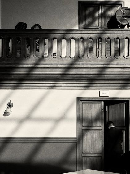 Shadows from the windows fall across the wall and floor, creating graphic patterns that change throughout the day.